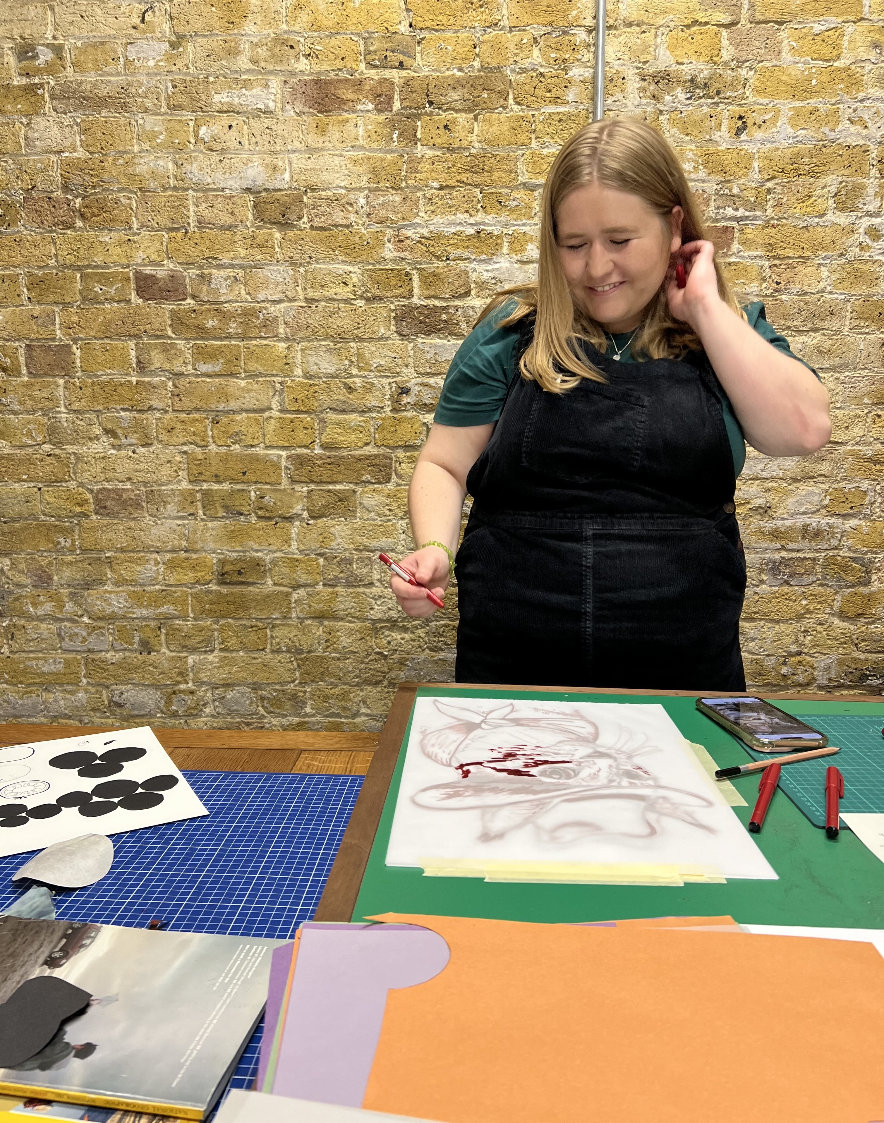 A participant absorbed in a hands-on creative session at a prepared workshop table